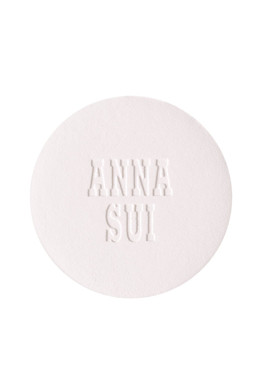 A round powder refill with engraved Anna Sui.